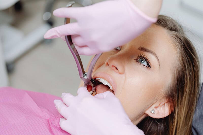 Dentist treating patient during dental procedure